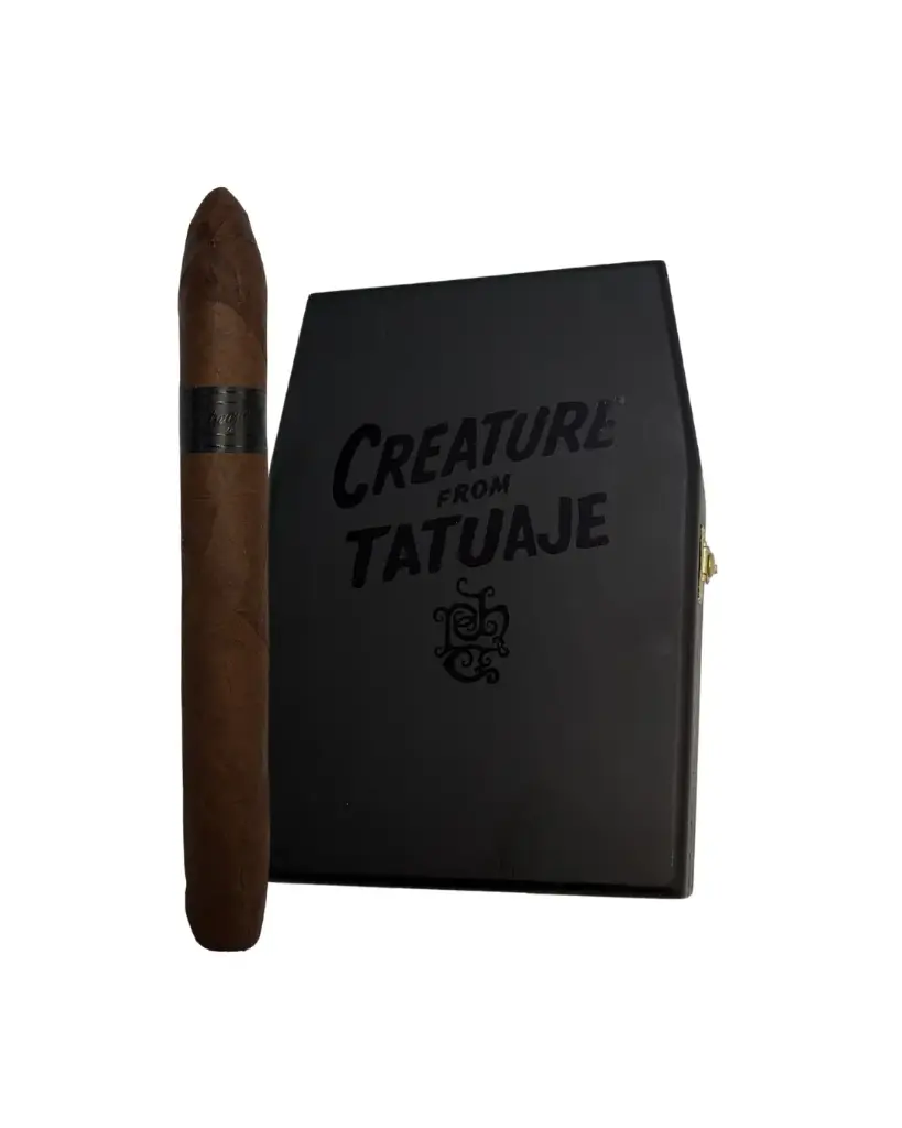 Creature From Tatuaje 6 78 x 52 Perfecto beside its black coffin box.webp